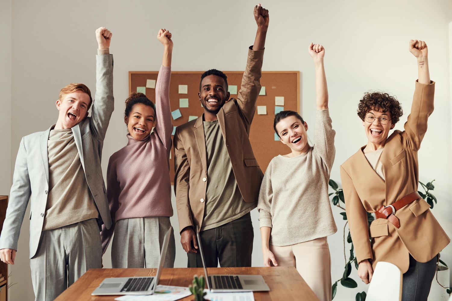 Young business professionals in a modern office setting, representing teamwork, strategic thinking, and analytical skills essential for navigating global market shifts with an MBA.